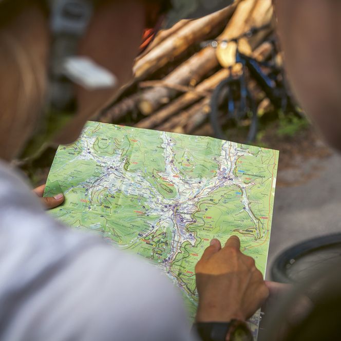 Biker schauen auf die Mountainbikekarte von Baiersbronn
