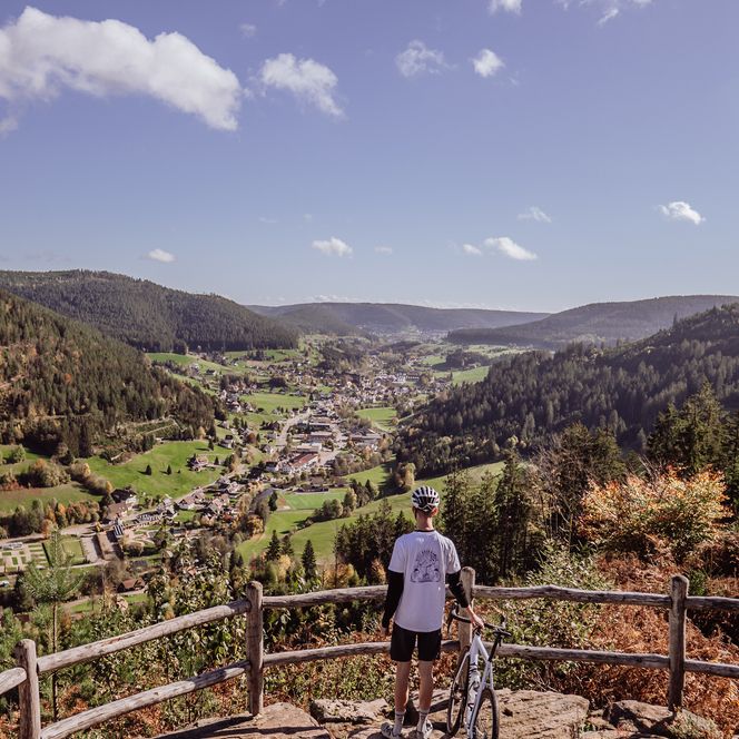 Eine Person steht mit dem Gravelbike am Aussichtspunkt der Walterhütte in Baiersbronn