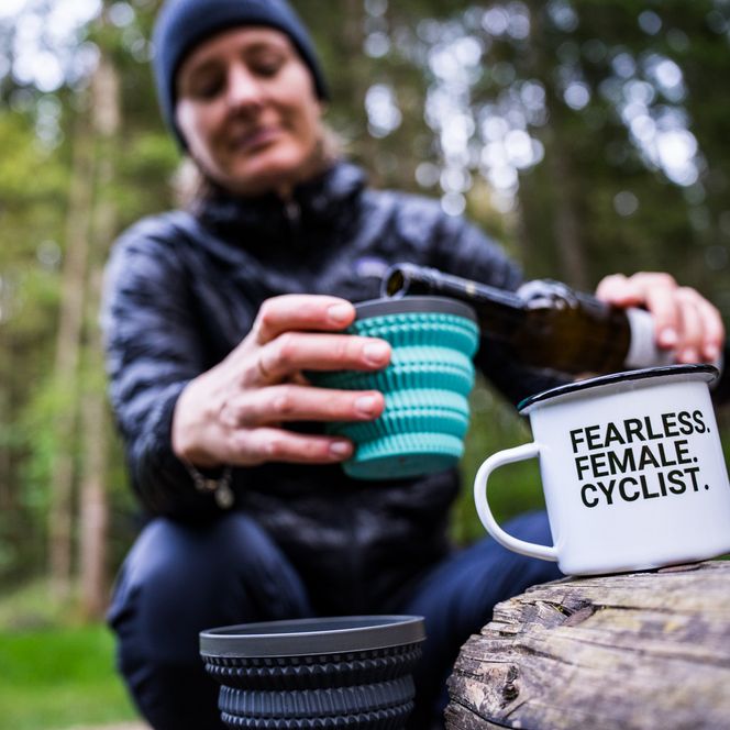 Eine Frau füllt ein Getränk in ihren Becher