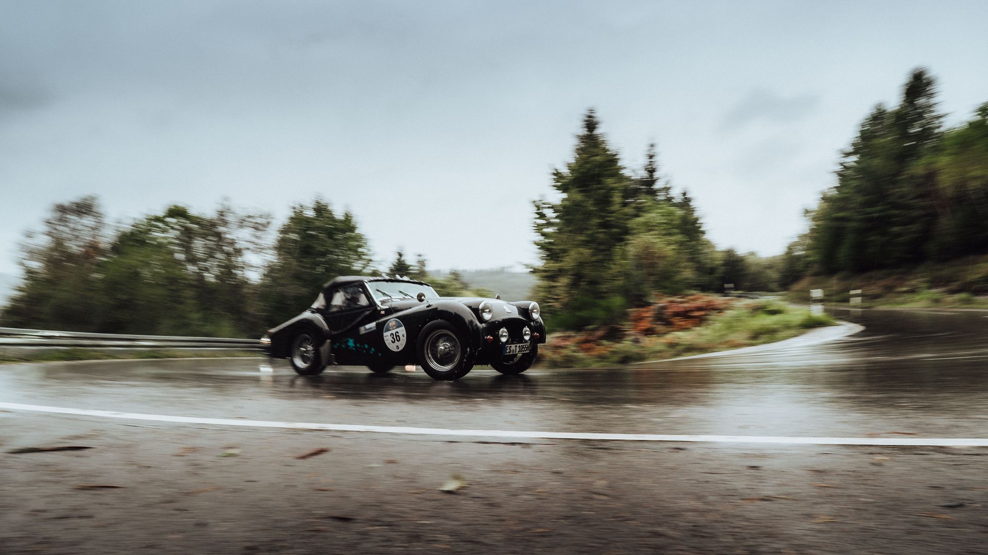 Ein schwarzer Oldtimer fährt um eine Kurve bei der Baiersbronn Classic